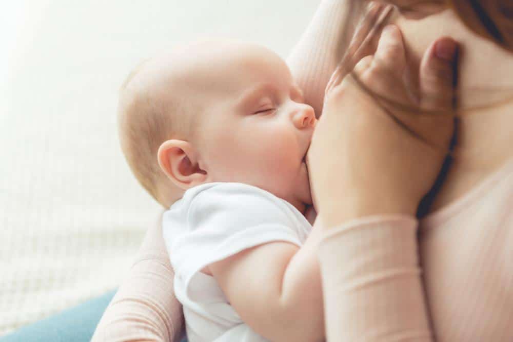 Mother breastfeeding young baby
