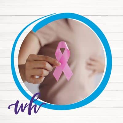 Women holding up pink breast cancer ribbon