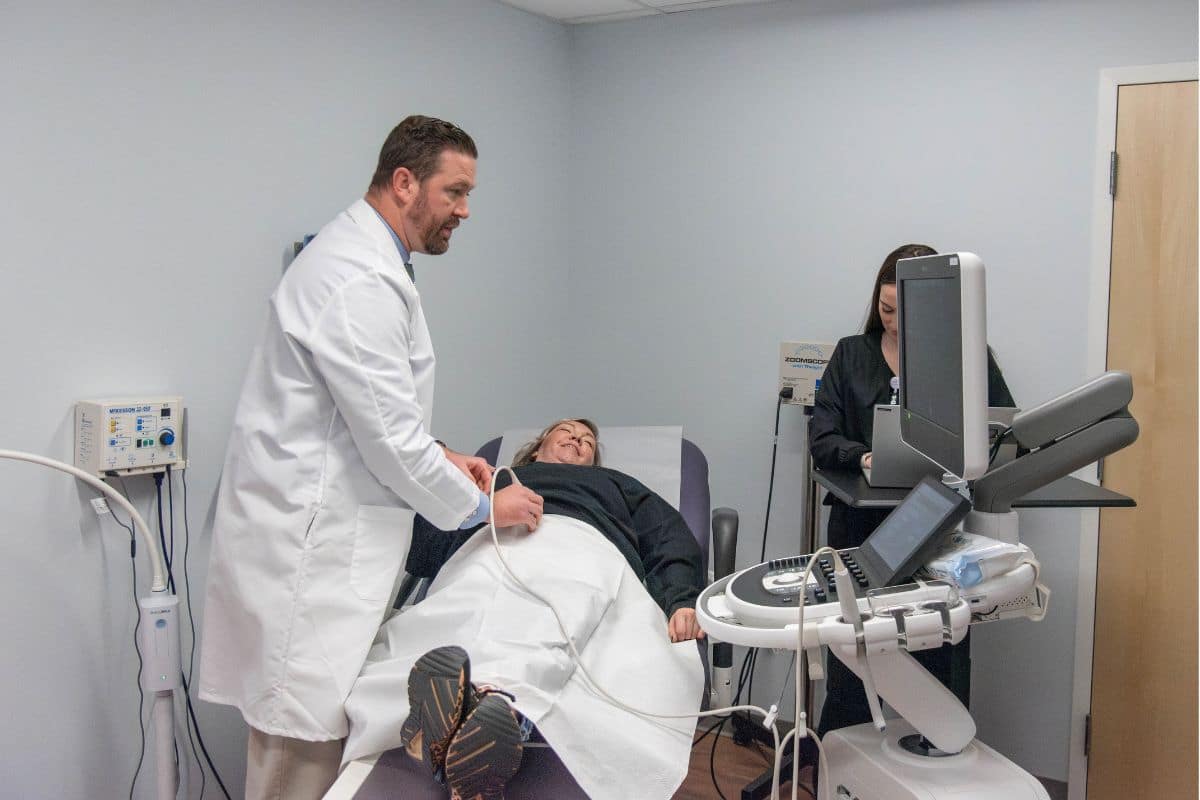 Doctor doing ultrasound on patient