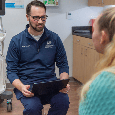 Whcva doctor talking to a female patient, representing pregnancy trimesters