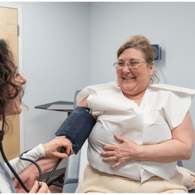 Patient receiving medical check-up at women’s health of central virginia, representing managing mood swings during menopause
